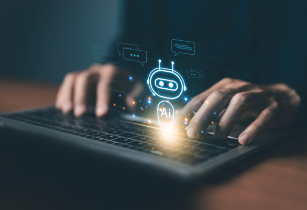 Close de usuário interagindo com computador onde surge um ícone de robô com a inscrição "AI", representando a integração de sistemas de IA corporativa para suporte e eficiência operacional.